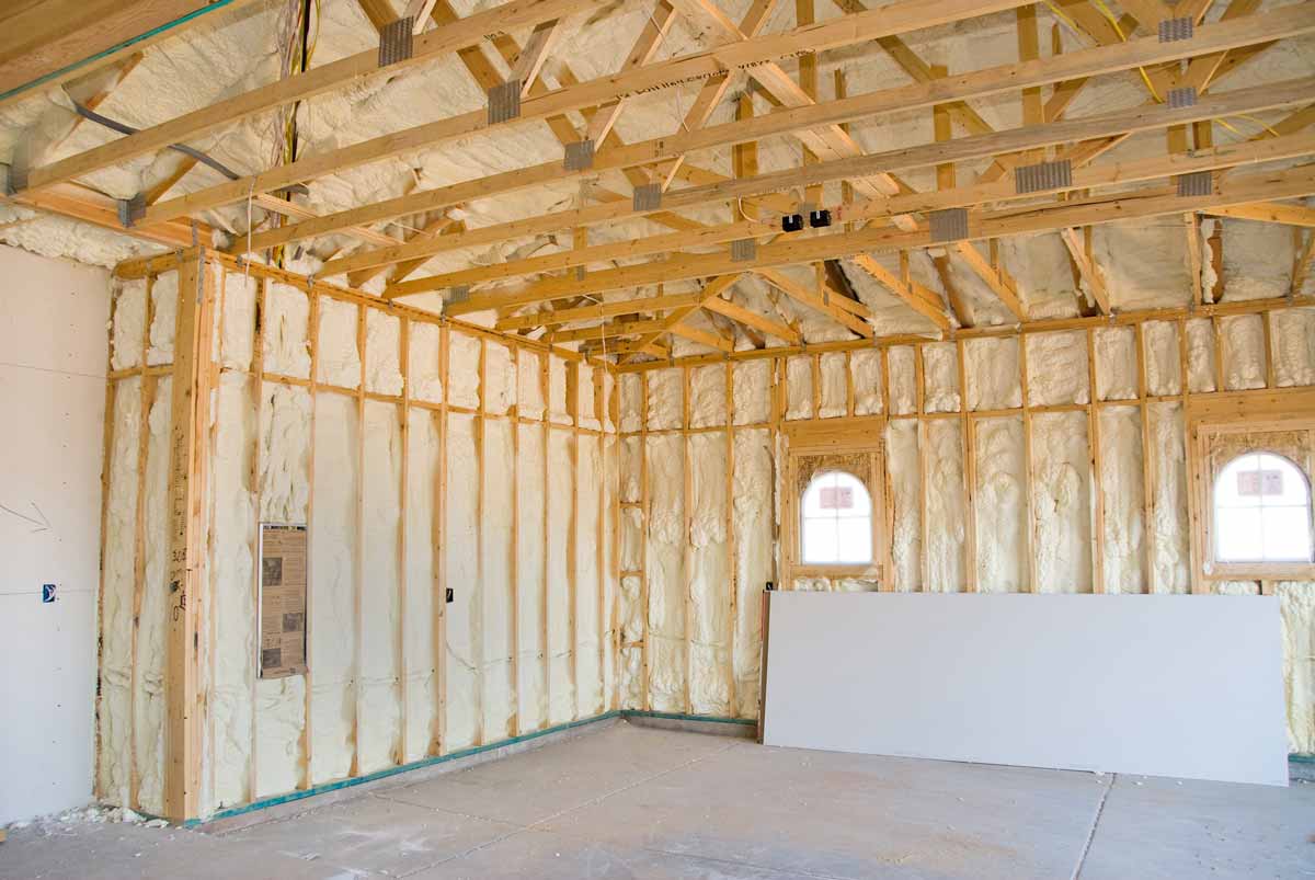 In-progress home construction with fresh spray foam insulation