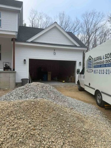 Truck with the Suppa  Sons Overhead Doors logo on a job site