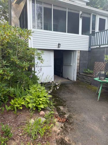 An old, outdated, dirty door on a one-car garage