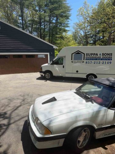 Truck with the Suppa  Sons Overhead Doors logo on a job site