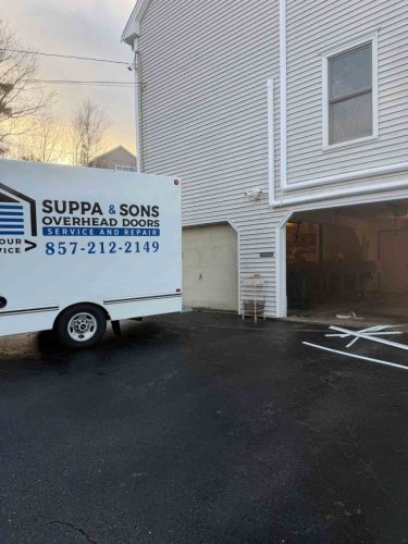 Truck with the Suppa  Sons Overhead Doors logo on a job site