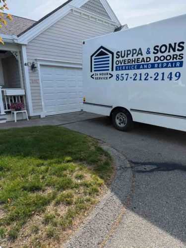 Truck with the Suppa  Sons Overhead Doors logo on a job site