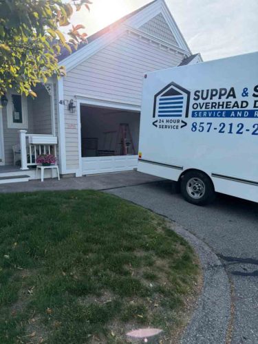 Truck with the Suppa  Sons Overhead Doors logo on a job site